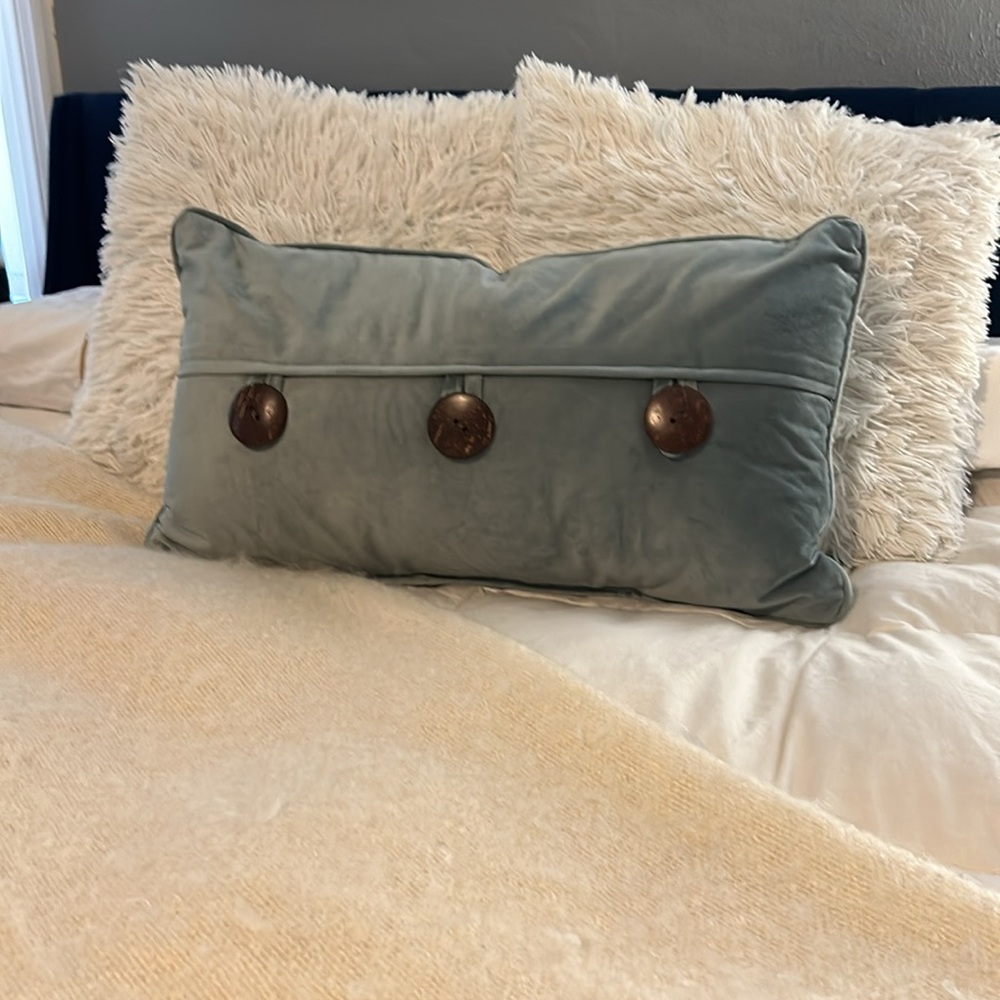 Sage green throw pillow with oversized button detail